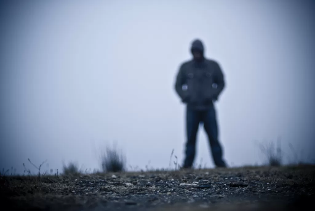Blurred Hooded Figure In Fog