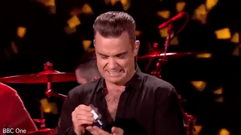 Robbie Williams echándose gel de manos