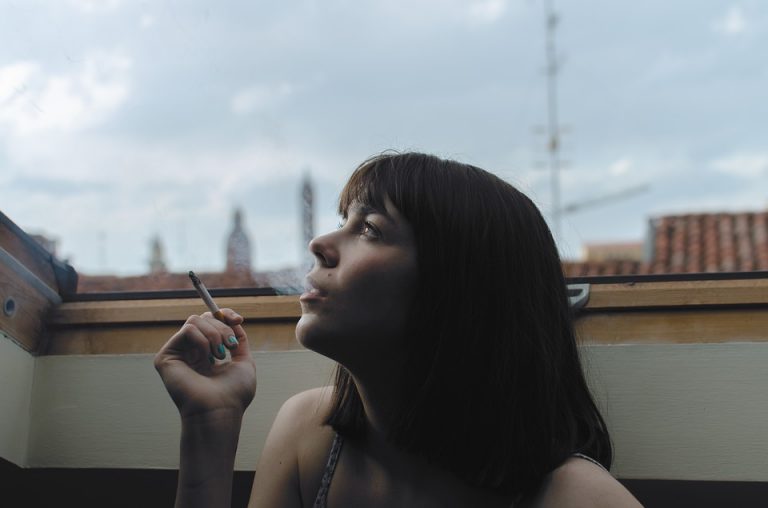 Mujer fumando en una terraza