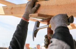 Construction Worker Build A Construction From Wooden Beams