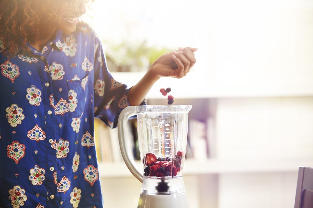 Woman Making A Smoothie At Home.