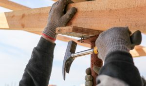 Construction Worker Build A Construction From Wooden Beams