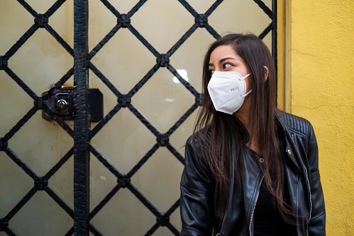 Young Hispanic Woman Wearing A Face Mask And Looking Away In Mexico City