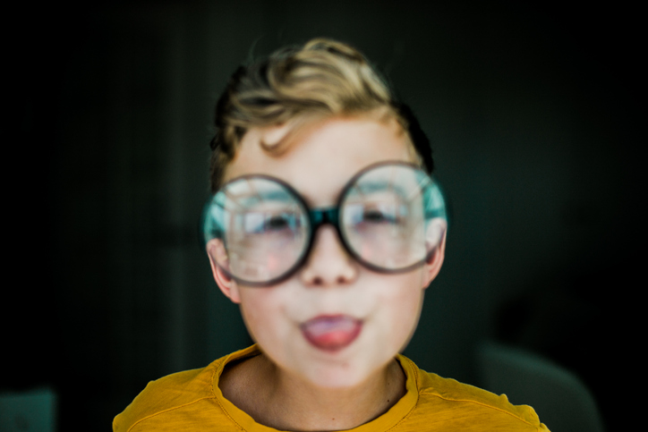 Blurred Portrait Of A Boy With Glasses.Myopia Concept